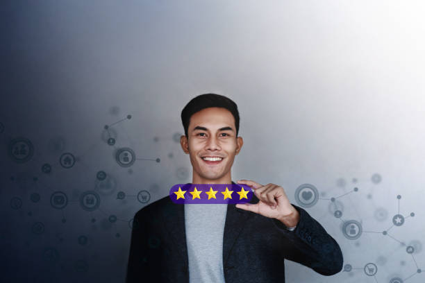 istock Customer Experience Concept. Young Businessman with Happy Face Showing his Five Star Services Rating Satisfaction. Happy Client's Feedback and Online Review. Surrounded by Network Icons 1140756224