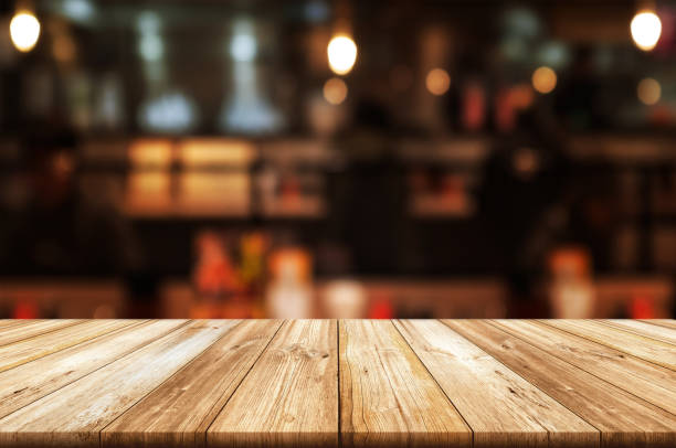 istock Empty wooden table top with blurred coffee shop or restaurant interior background. 1140756832