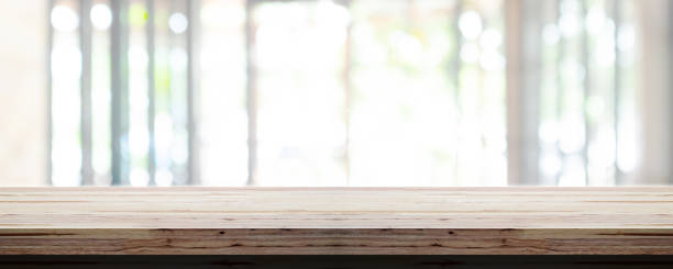 istock Empty wooden table top with blur office interior background, Panoramic banner. 1140756982