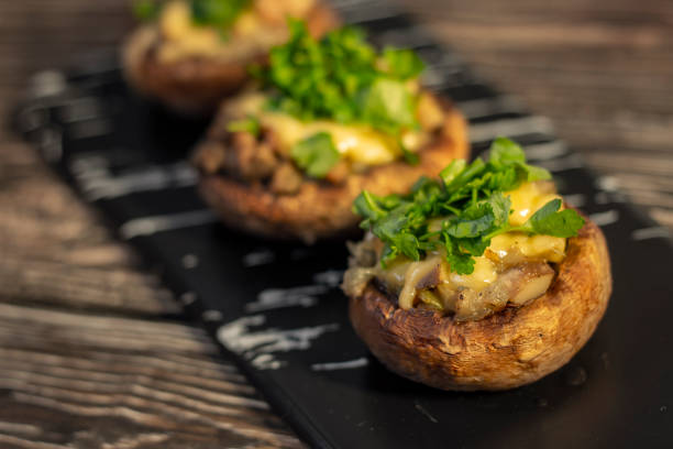 istock Stuffed mushrooms on a rough wooden surface 1140757515