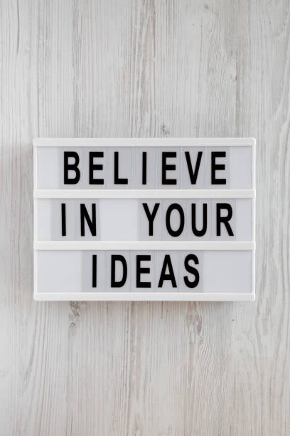 istock 'Believe in your ideas' words on modern board over white wooden surface. Flat lay, from above, overhead. 1140757713