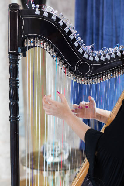 istock musician plays the harp 1140759992