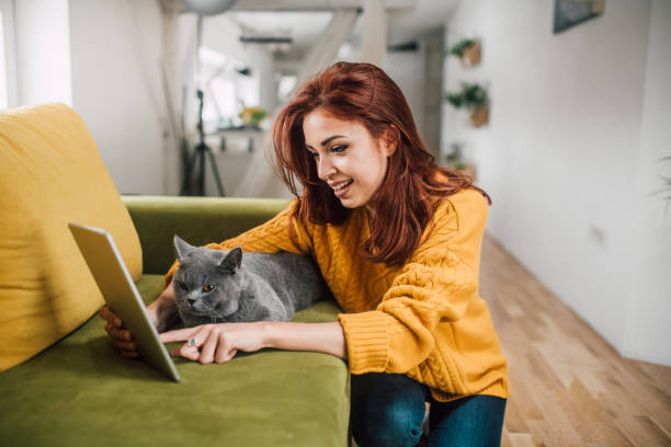 istock Happy girl with digital tablet and a cat 1140760081