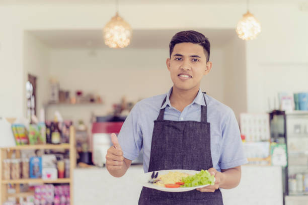 istock Asian waiters are serving food to couples with smiling. 1140764145