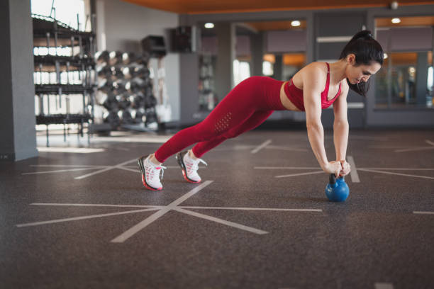 istock Woman performing push-ups on kettlebell 1140764317