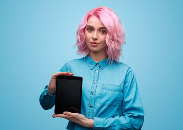 istock Pretty woman demonstrating tablet 1140764339