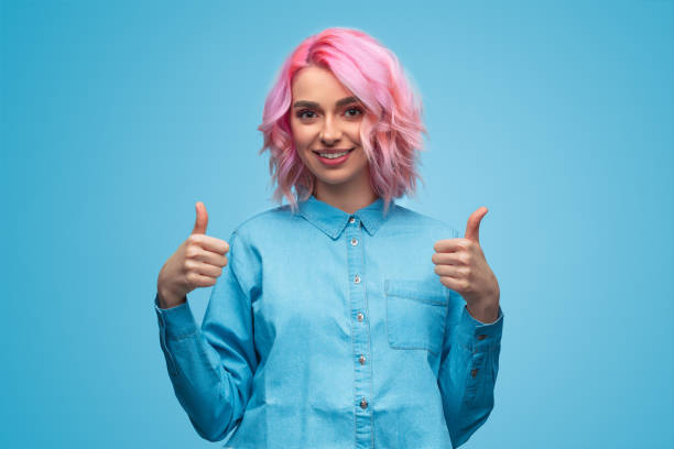 istock Charming colorful modern woman showing thumbs up 1140764347