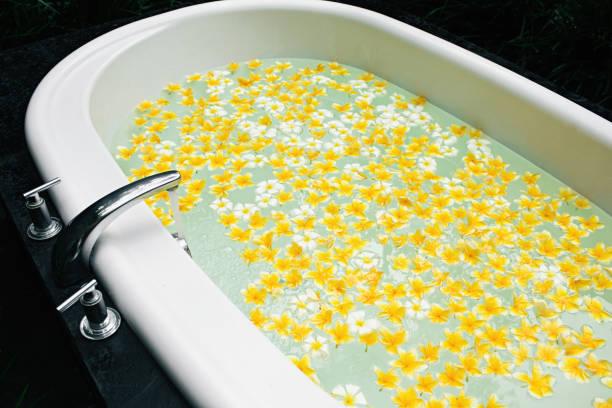 istock Bath with yellow flowers in tropics. 1140768559