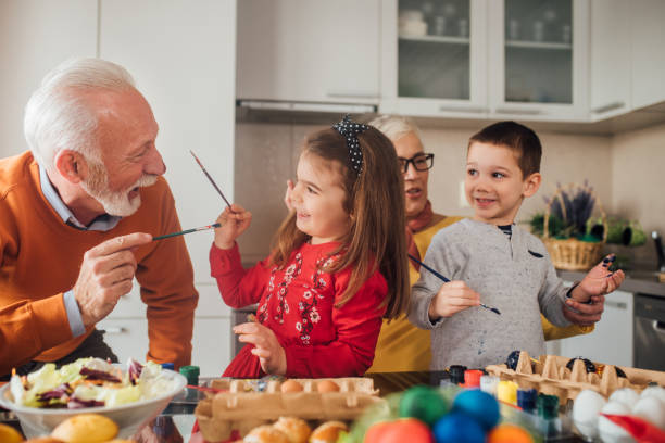 istock Children decorating Easter eggs with grandparents 1140772870