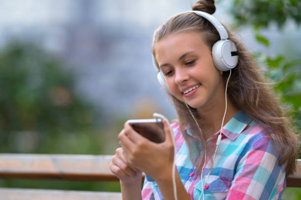istock Smiling young woman selecting a new soundtrack 1140773602