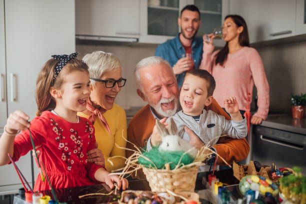 istock Old couple petting a rabbit with grandchildren 1140777634
