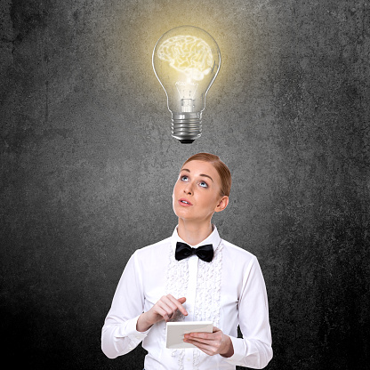 Thoughtful businesswoman with glowing new business ideas