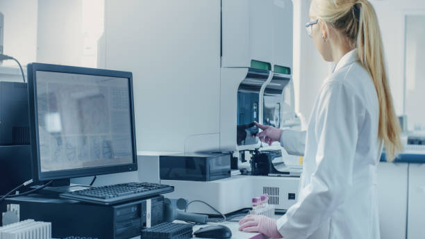 istock Female Research Scientist Working with Medical Analyzing Machine for Testing Tubes with Blood Sample. Scientist Works in Innovative Pharmaceutical Genetic Research Laboratory. 1140779532