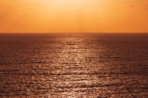 istock orange sun light at ocean seascape 1140779630