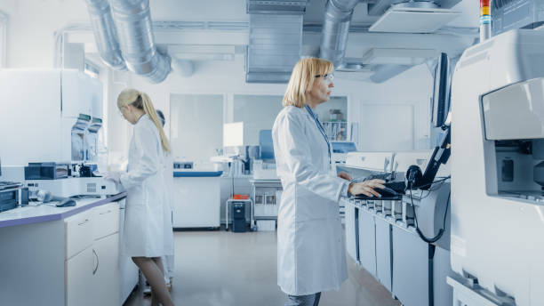 istock Team of Research Scientists Working On Computer, with Medical Equipment, Analyzing Blood and Genetic Material Samples with Special Machines in the Modern Laboratory. 1140779694