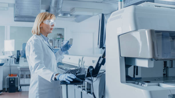 istock In Laboratory Female Scientist Analyzes Test Tube Data with Blood Samples with Personal Computer. Team of Researchers Work in Pharmaceutical Laboratory. 1140779714