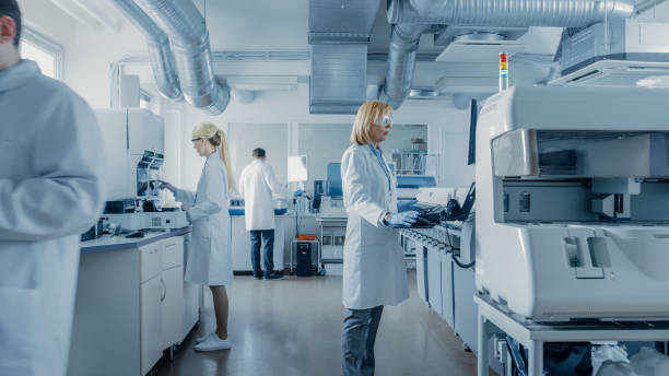 istock Team of Research Scientists Working On Computer, with Medical Equipment, Analyzing Blood and Genetic Material Samples with Special Machines in the Modern Laboratory. 1140779738