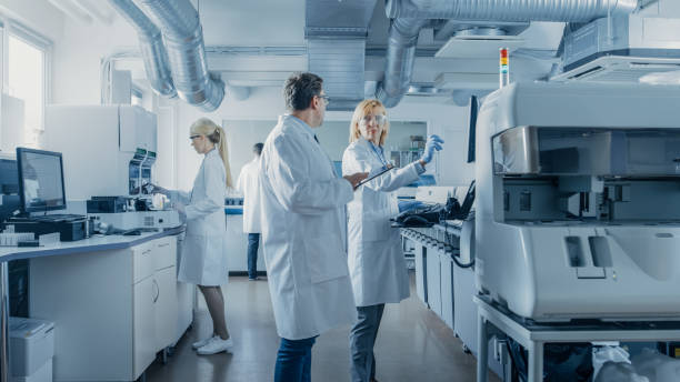 istock Team of Research Scientists Working On Computer, with Medical Equipment, Analyzing Blood and Genetic Material Samples with Special Machines in the Modern Laboratory. 1140779752