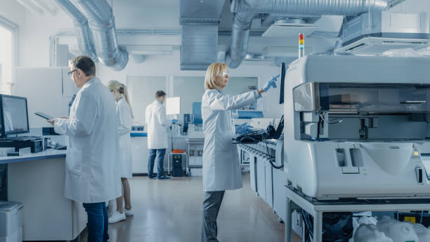 istock Team of Research Scientists Working On Computer, with Medical Equipment, Analyzing Blood and Genetic Material Samples with Special Machines in the Modern Laboratory. 1140779759