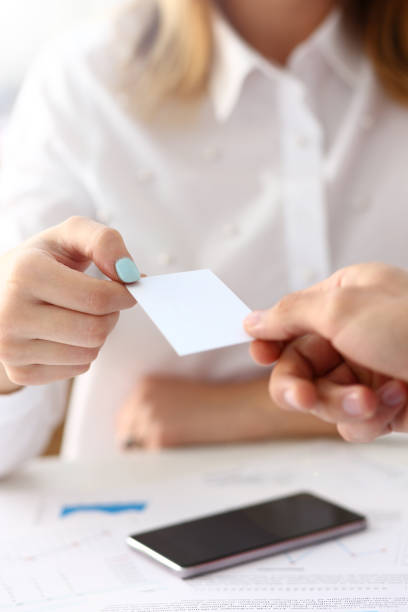 istock Female hand in suit give blank calling card 1140781468