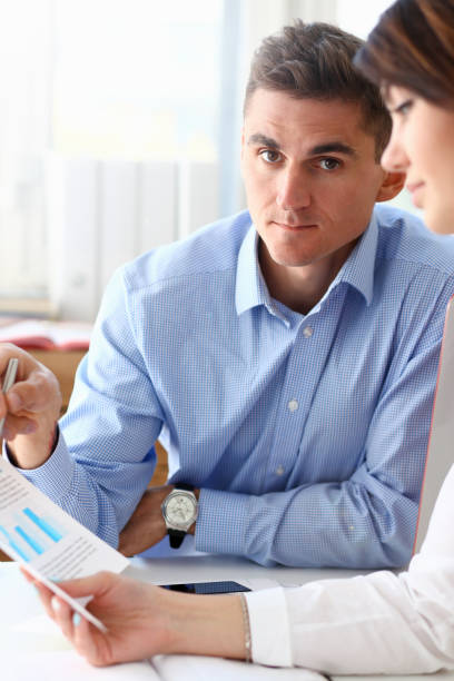 istock Group of people deliberate on problem with paper infographics 1140781474