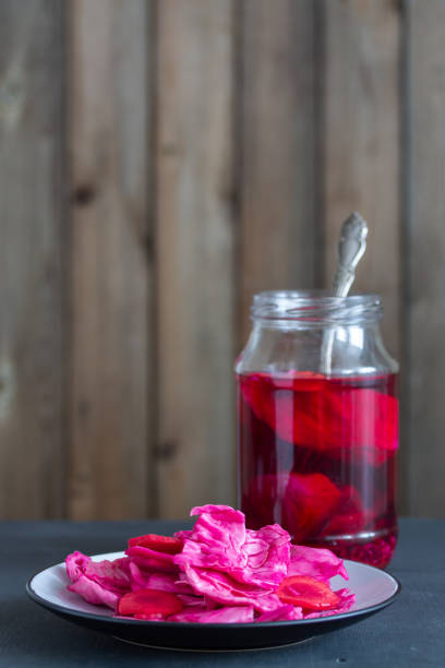 istock Canned fermented cabbage with beets, carrots on a white plate in a vertical orientation. Natural wooden background. 1140782049