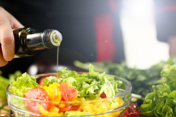 istock Cook holds bottle in hand and trickles olive 1140783227