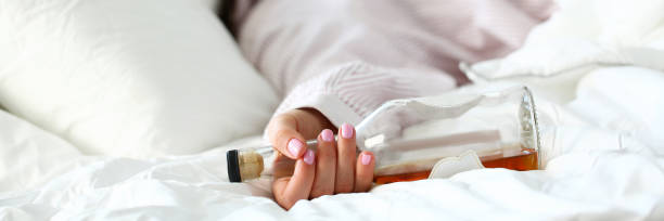 istock Young woman lying in bed deadly drunken 1140784531
