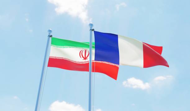 istock France and Iran, two flags waving against blue sky 1140784710