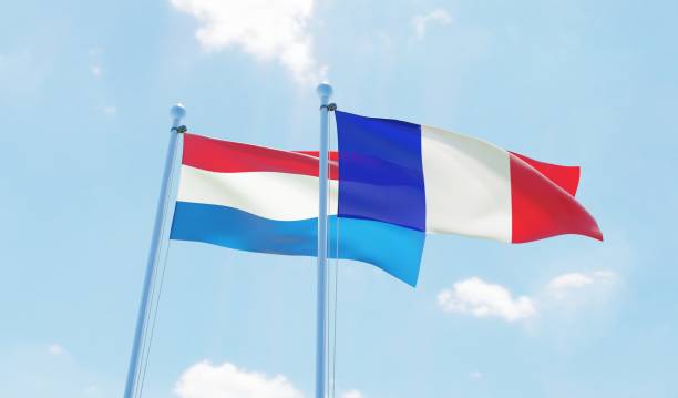 istock France and Netherlands, two flags waving against blue sky 1140784761