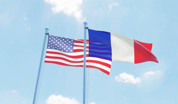istock France and USA, two flags waving against blue sky 1140786734