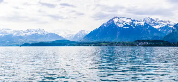 Niesen kulm and lake Thun ( Thunersee )  in fornt of Alps mountain in Bern Switzerland with cloudy sky