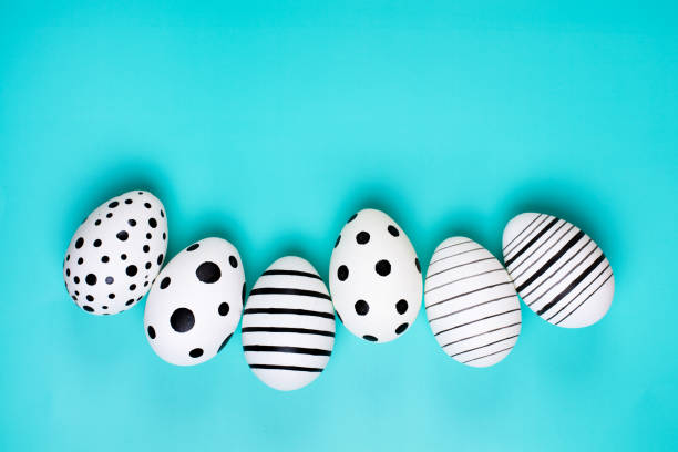istock Different graphic hand drawn eggs on blue pastel background. 1140790092