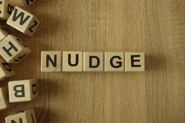 istock Nudge word from wooden blocks 1140790756