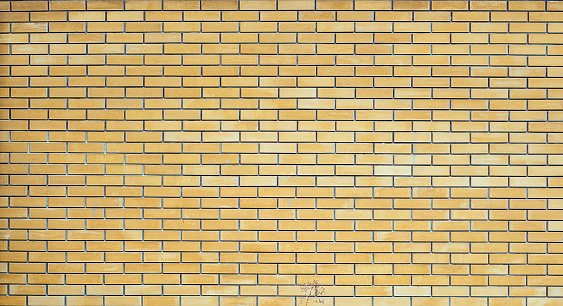 Empty Vintage Yellow Brick Wall Texture. Building With Grunge Damaged. Horizontal texture
