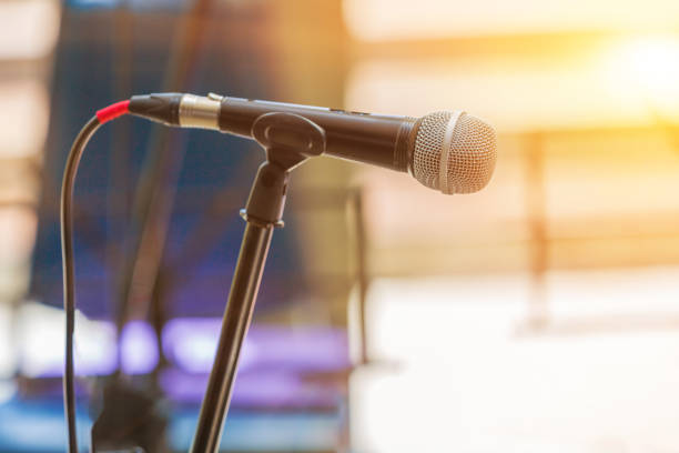 istock Microphone on abstract blurred indoor background with sunlight of sunset 1140793893