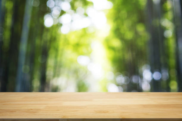 istock empty wood table top over blur outdoor green nature background. 1140795203