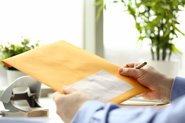 istock Businessman hold hand yellow mail envelope 1140796998
