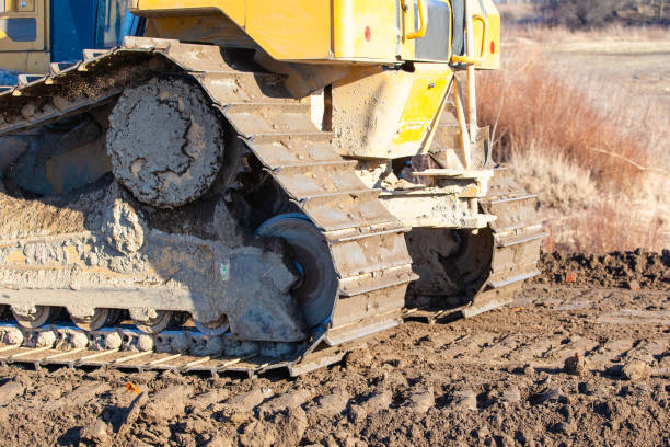 istock yellow crawler bulldozer rakes the ground 1140797053