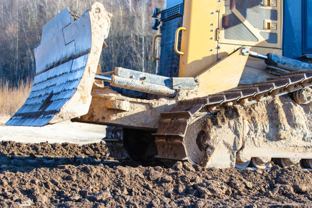 istock yellow crawler bulldozer rakes the ground 1140797065