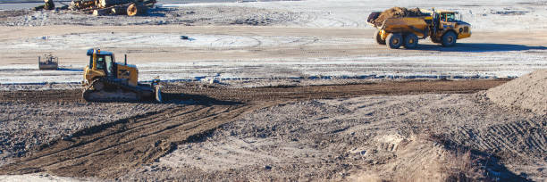 istock bulldozer and big truck at a construction site 1140797070