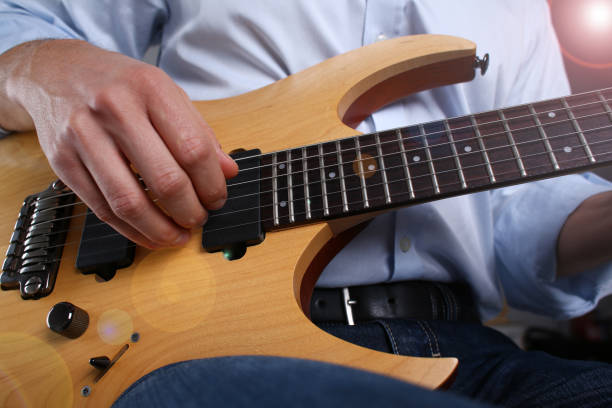 istock Male arms playing classic shape electric guitar 1140798294