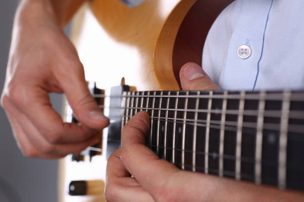 istock Male arms playing classic shape electric guitar 1140798297