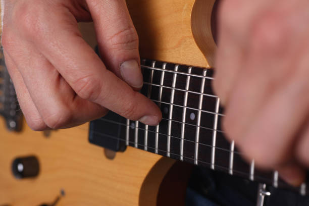 istock Male arms playing classic shape electric guitar 1140798312