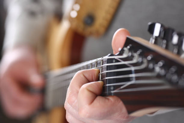 istock Male arms playing classic shape electric guitar 1140798326