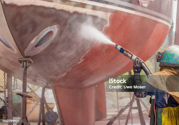 Sandblasting A Yacht Stock Photo - Download Image Now - Sandblaster, Nautical Vessel, Cleaning