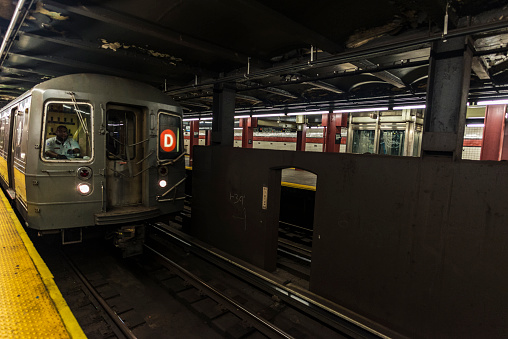 New York City, USA - July 26, 2018: Train car in motion with its driver in a subway station of New York City, USA