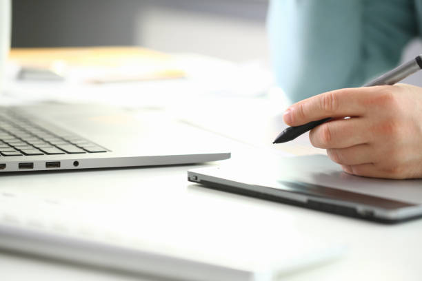istock A young designer holds a pen from a tablet in his 1140800942