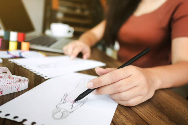istock fashion / creative designer working with sketching notebook at modern home studio, selective focus 1140801004
