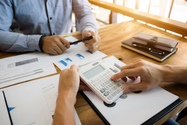 istock two businessman working together with financial report 1140801061